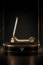 24K Gold Segway Glide Royale on a round black plinth, gold deck and wheels below a crystal-set steering column