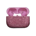 Rose Swarovski AirPods Pro 3 open, soft rose-pink earbuds in a matching pink interior, the case covered in medium rose-pink crystals, white ear tips at the centre