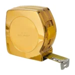 Metron Gold Tape Measure seen closer at an angle, the polished 24K Gold front engraved 24K GOLD GOLDPRIVÉ beside the yellow lock button and steel end hook