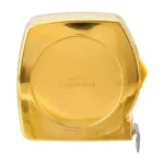 Metron Gold Tape Measure face-on, a round 24K Gold front engraved 24K GOLD and GOLDPRIVÉ with the yellow lock button on its edge